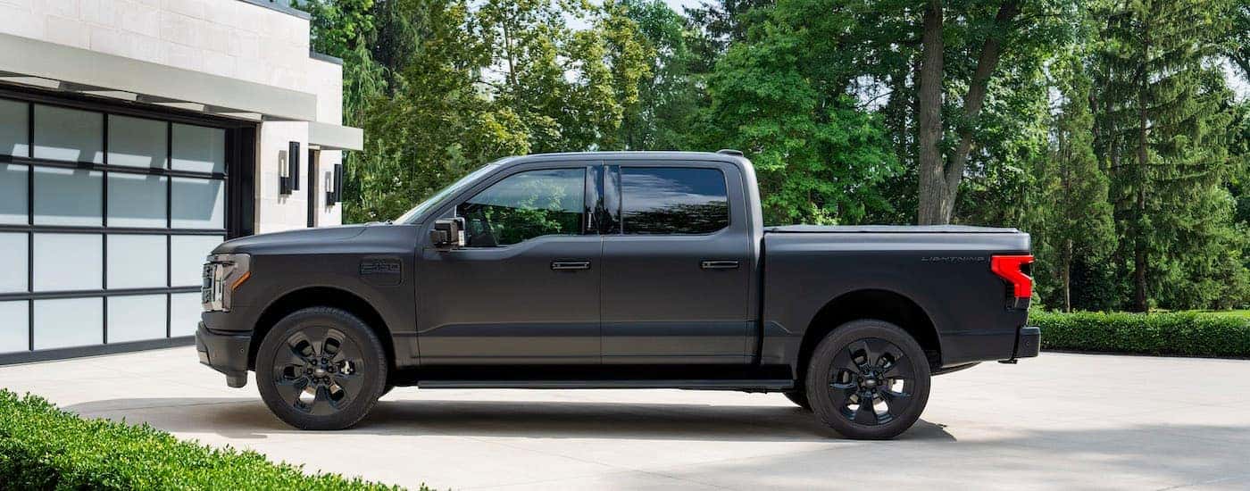 A black 2025 Ford F-150 Lightning Platinum is shown from the side.