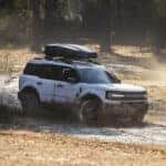 A white 2025 Ford Bronco Sport for sale near Indianapolis is kicking up mud.