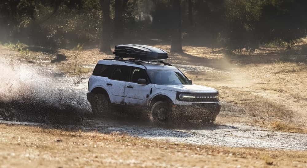 A white 2025 Ford Bronco Sport for sale near Indianapolis is kicking up mud.