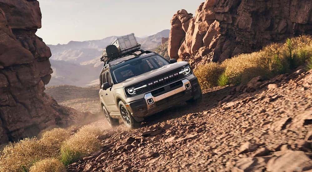 A tan 2025 Ford Bronco Sport Badlands is shown off-roading.
