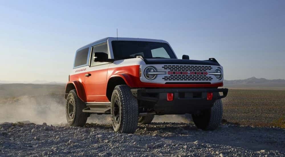 A mostly red 2025 Ford Bronco Stroppe Special Edition is parked off-road.