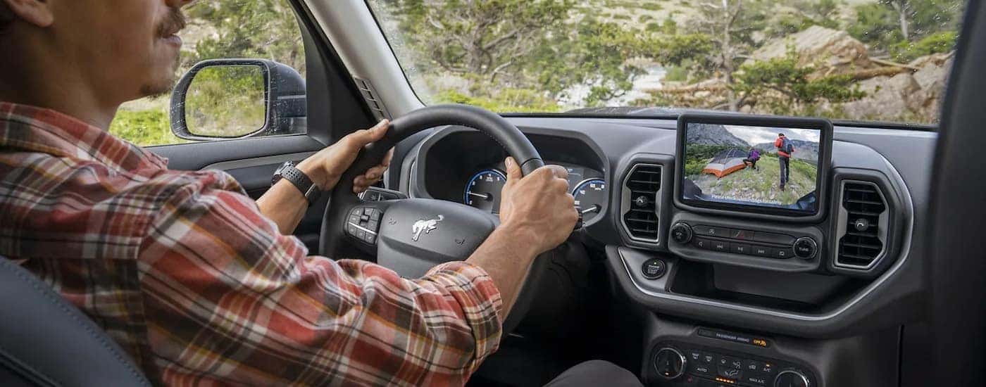 A man driving a used 2023 Ford Bronco Sport for sale near Carmel on a test ride.