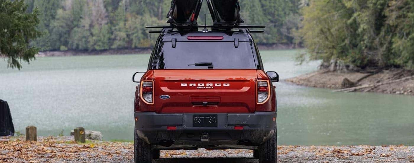 A red 2024 Ford Bronco Sport parked near a river.