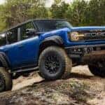 A blue 2025 Ford Bronco Raptor for sale near Carmel parked off-road..