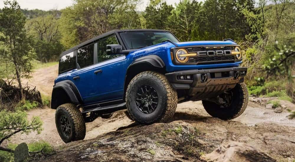 A blue 2025 Ford Bronco Raptor for sale near Carmel parked off-road.
