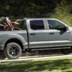 A gray 2025 Ford F-150 for sale near Carmel driving off-road.