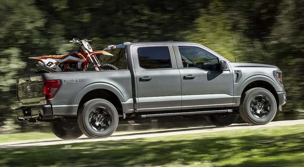 A gray 2025 Ford F-150 for sale near Carmel driving off-road.