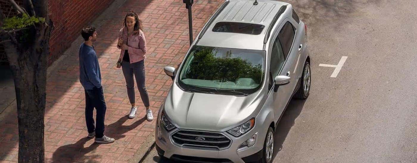 A silver 2022 Ford EcoSport parked in a city.