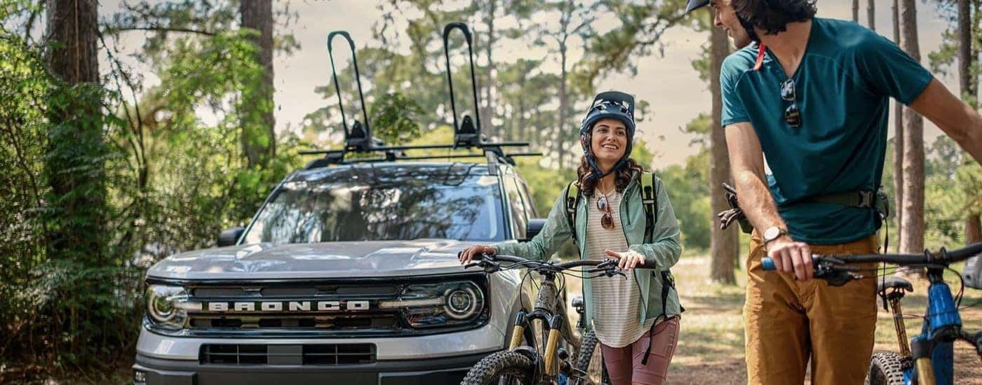 A silver 2023 Ford Bronco Sport near bikers.