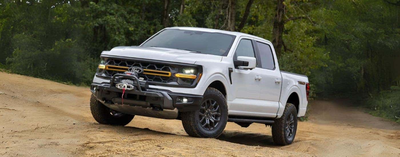 A white 2024 Ford F-150 Tremor parked off-road.