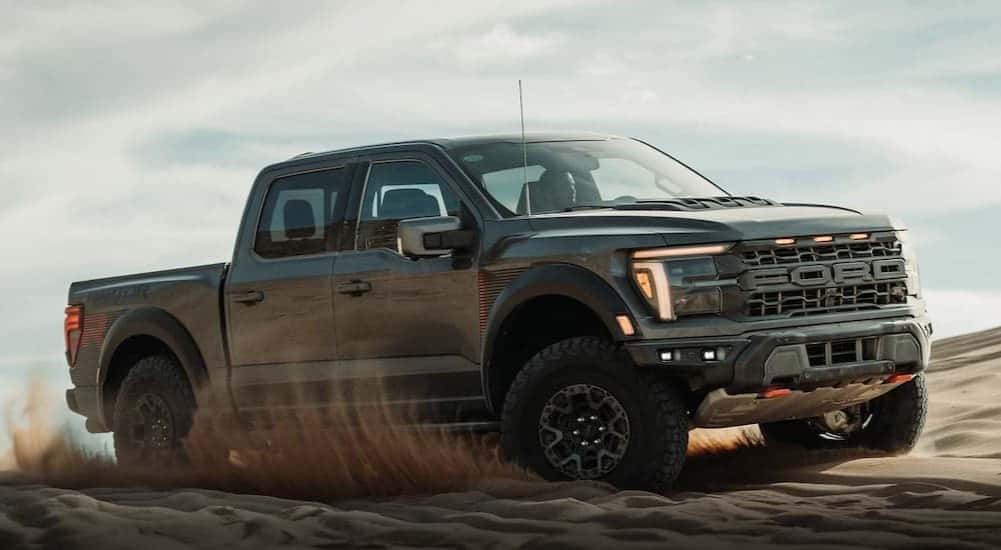 A gray 2025 Ford F-150 Raptor off-roading.