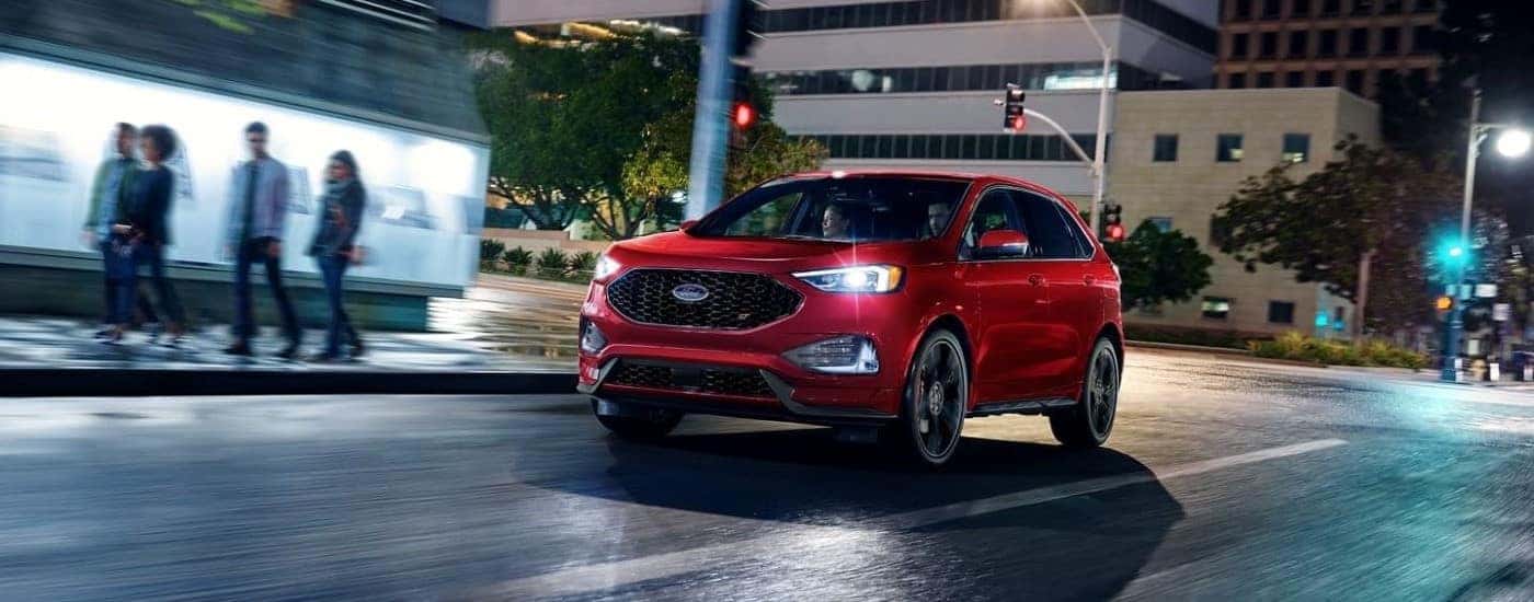Red 2023 Ford Edge ST driving from a Ford dealer near Crawfordsville.