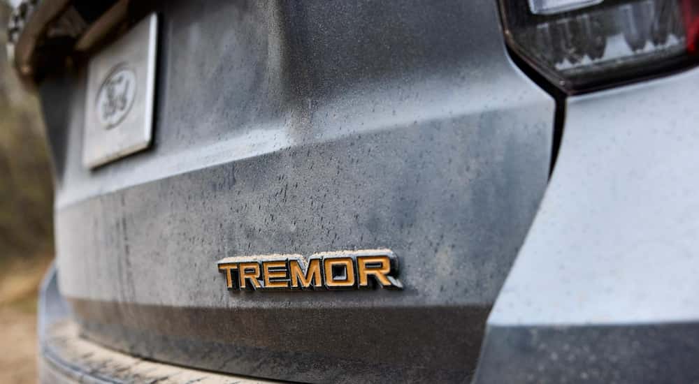 The Tremor badge on the hatch of a silver 2026 Ford Explorer Tremor.
