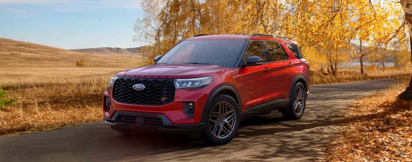 A red 2026 Ford Explorer parked on a fall day.
