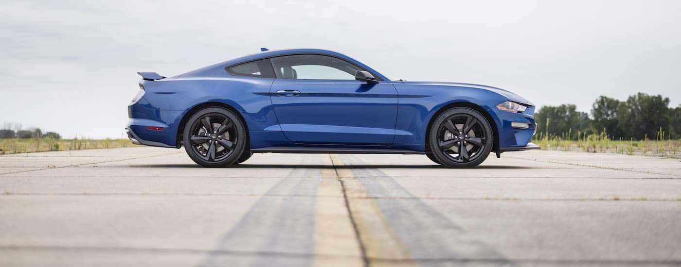 A blue 2022 Ford Mustang Stealth Edition is shown from the side after leaving a Ford dealer near Whitestown.