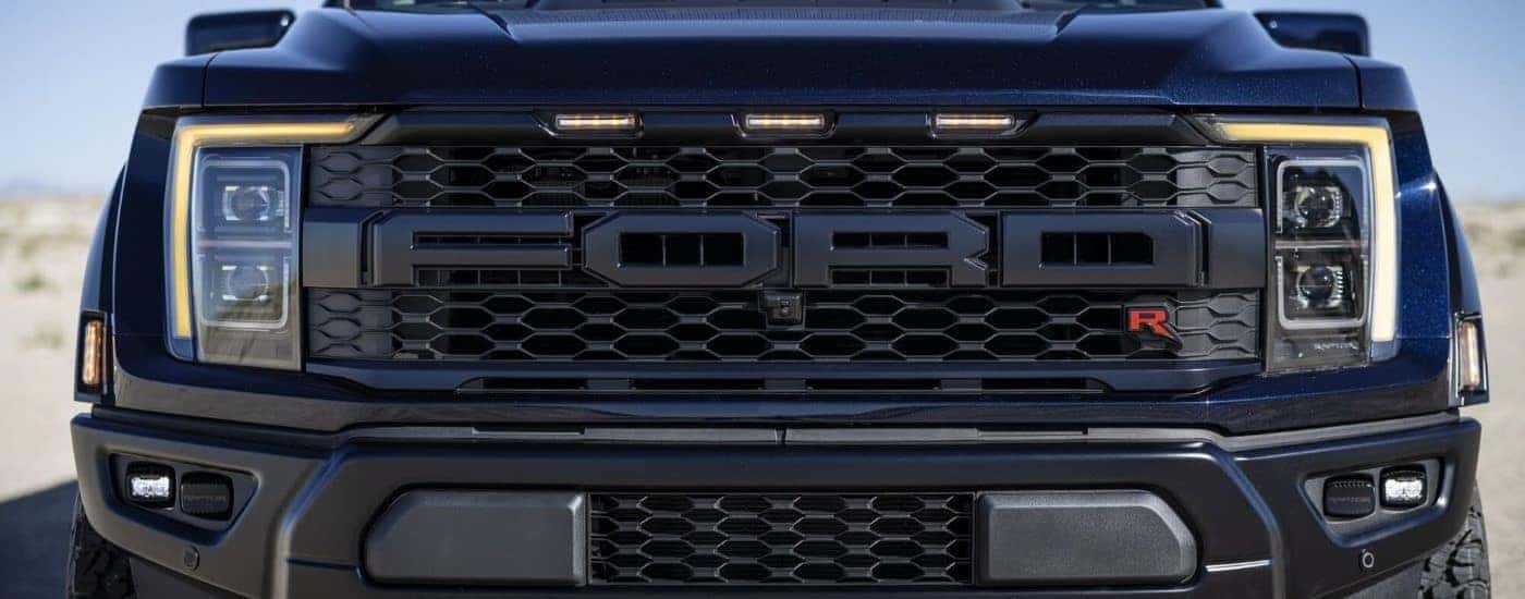 A close up shows the grille on a black 2023 Ford F-150 Raptor R.