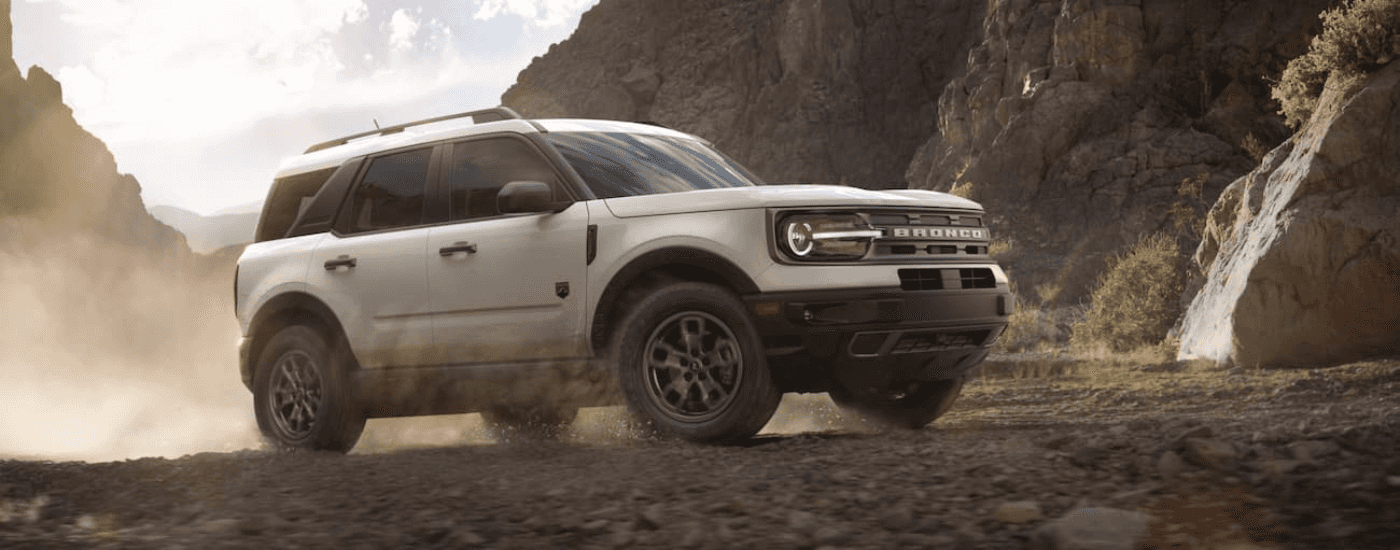 A white 2022 Ford Bronco Sport Big Bend is shown driving on a dusty trail.