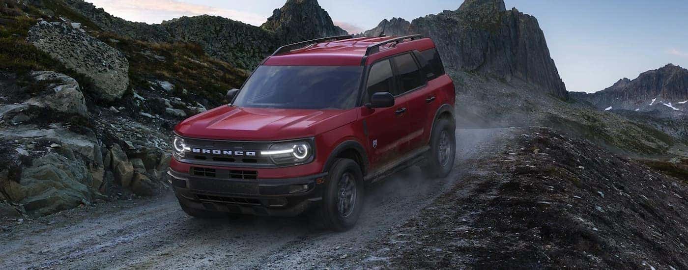 A red 2022 Ford Bronco Sport Big Bend is shown driving on a dirt trail.