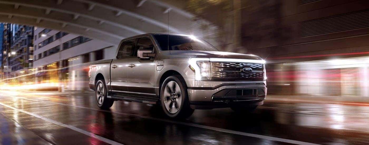 A silver 2024 Ford F-150 Lightning driving through a tunnel
