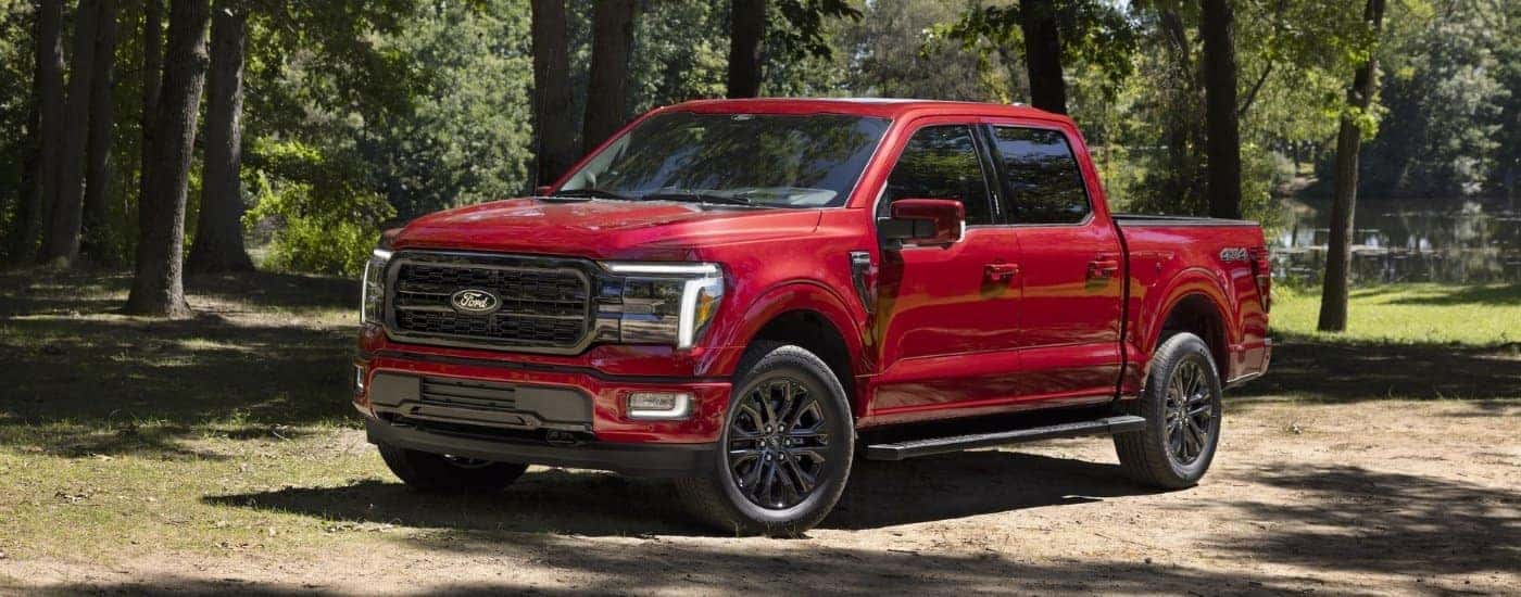 A red 2024 Ford F-150 XLT parked off-road and angled left after visiting a Ford dealer near Frankfort.