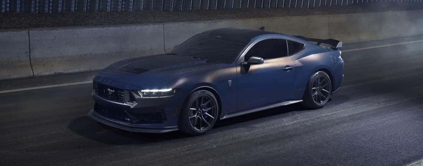 A blue 2024 Ford Mustang Dark Horse is shown from the side while in a tunnel