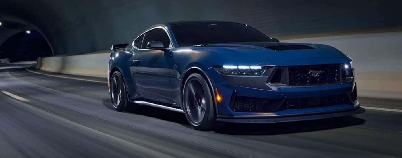 A blue 2024 Ford Mustang Dark Horse is shown from the front