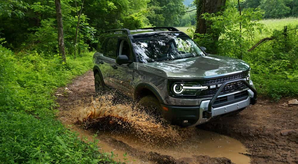 Silver 2026 Ford Bronco Sport driving off-road in a forest.