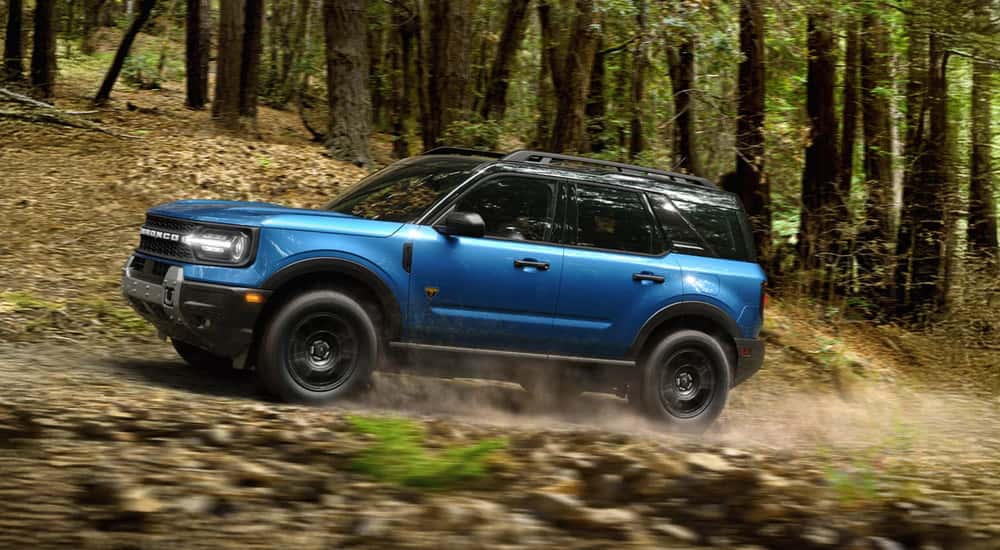Blue 2026 Ford Bronco Sport Badlands off-roading on a dirt trail