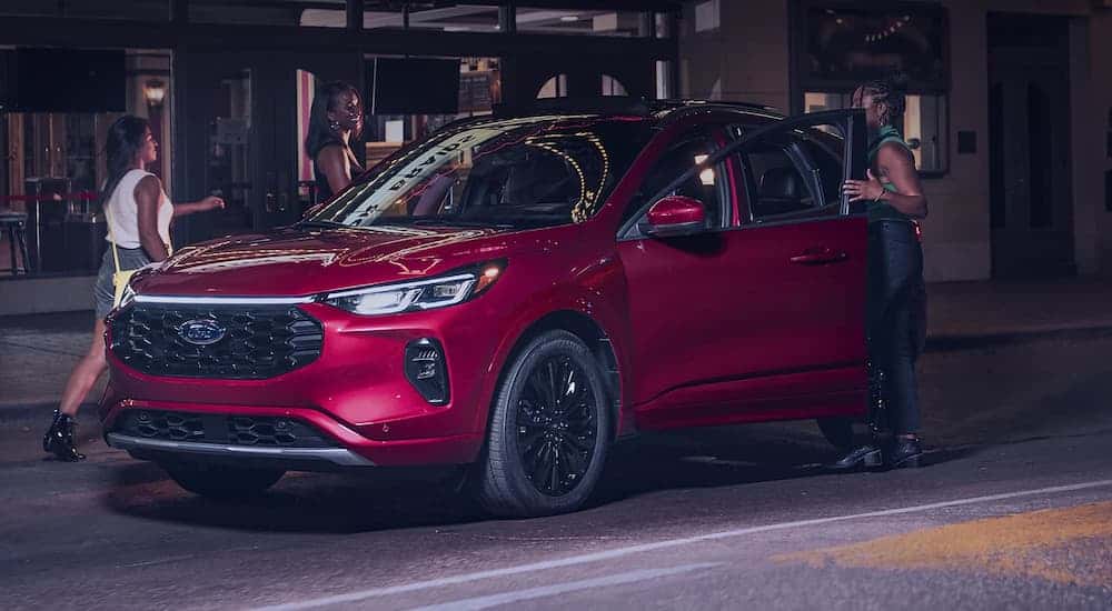 Red 2026 Ford Escape parked by a curb.