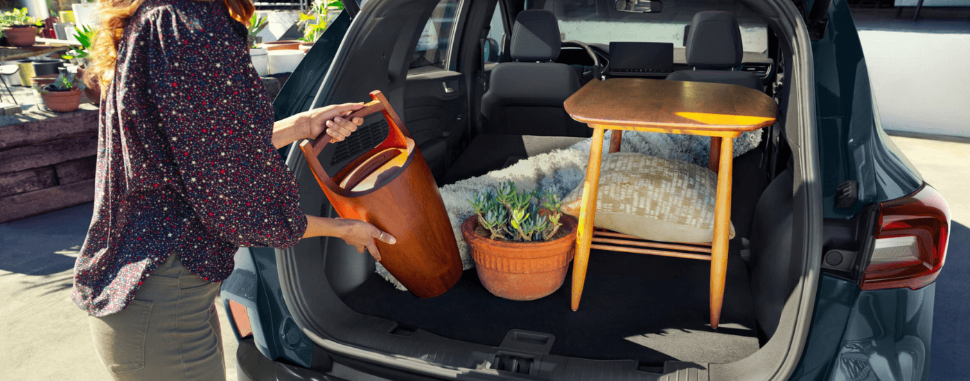 A person loading the trunk of their 2026 Ford Escape