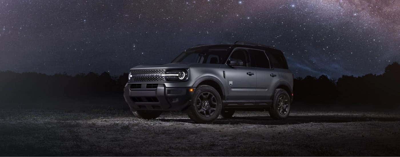 A gray 2025 Ford Bronco Sport Big Bend parked under a starry night sky.