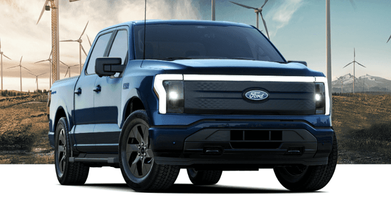 Ford F-150 Lightning EV parked in front of windmills