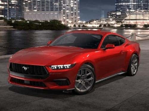 2024 Ford Mustang parked outside a city at night