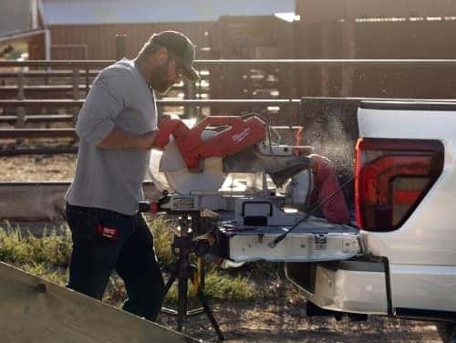 2025 Ford F-150 view of man using pro power onboard to use a power tool