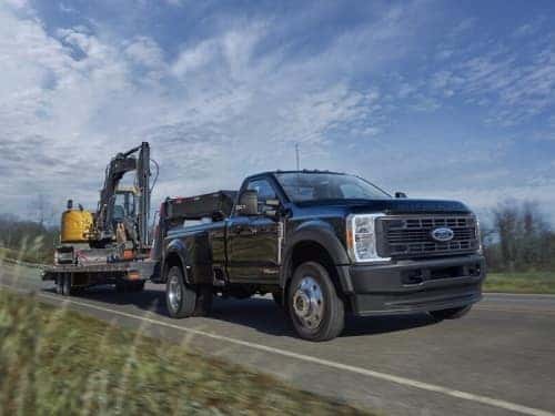 2025 Ford Super Duty towing a flat bed