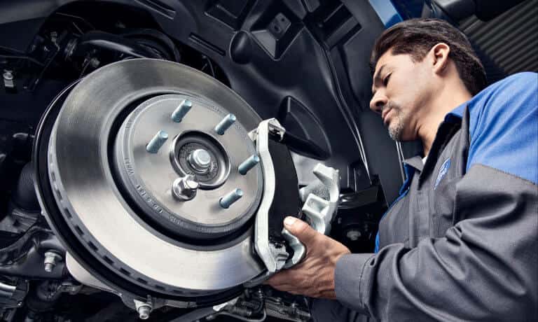 Ford Service Technician Working On Brakes