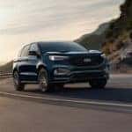 The all new 2024 Ford Edge driving up a hill during a sunset