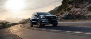 The all new 2024 Ford Edge driving up a hill during a sunset