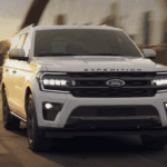 2024 Ford Expedition in white paint driving along a bridge in Macon, GA.