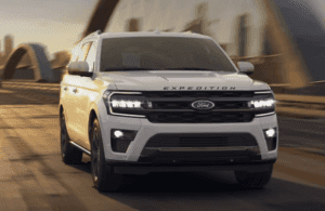 2024 Ford Expedition in white paint driving along a bridge in Macon, GA.