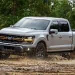 Gray Ford F-150 driving through the mud.