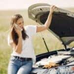 Woman upset her car broke down on her cell phone.