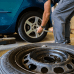 Ford mechanic rotating a car tire.