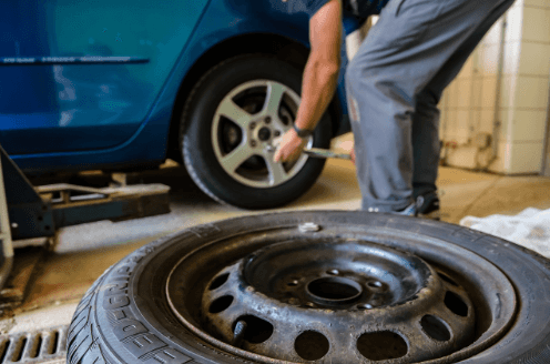 Ford mechanic rotating a car tire.