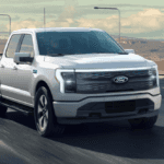 2025 Ford F-150 Lightning driving down a busy Georgia highway.