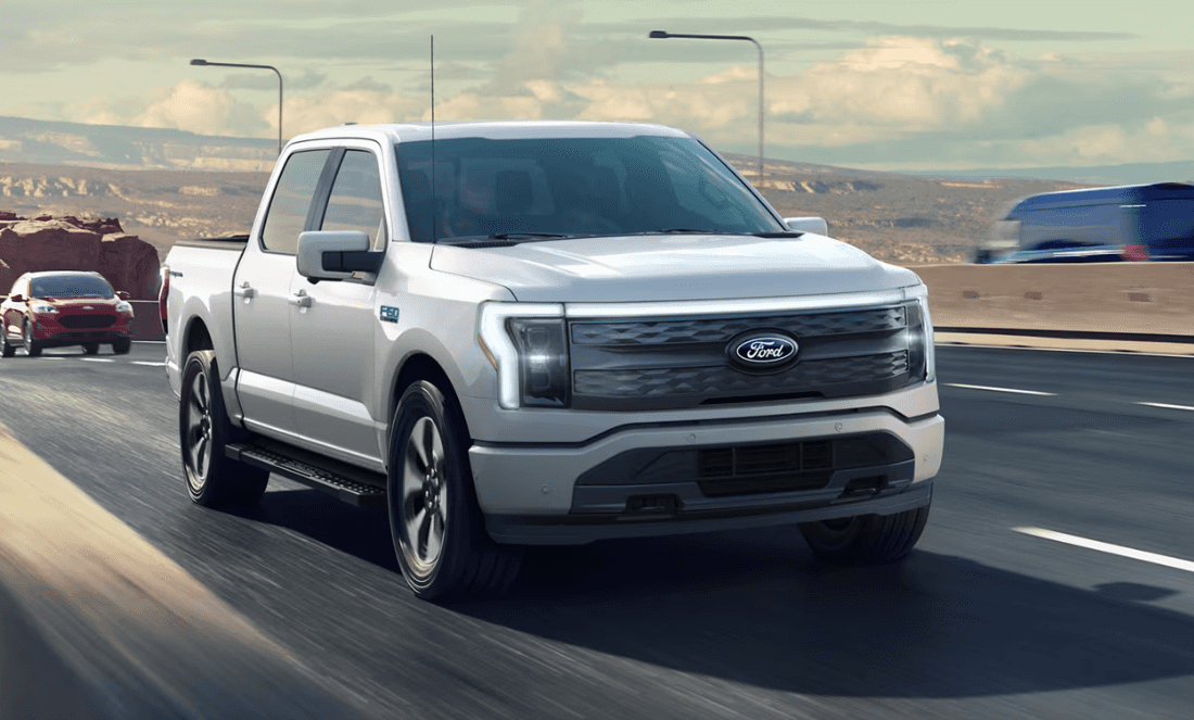 2025 Ford F-150 Lightning driving down a busy Georgia highway.
