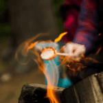 Roasting marshmallow over a campfire in Macon, GA.