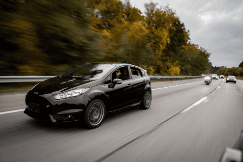Black Ford Vehicle traveling down a highway in Georgia.