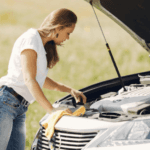 Woman performing road side maintenance on her vehicle.
