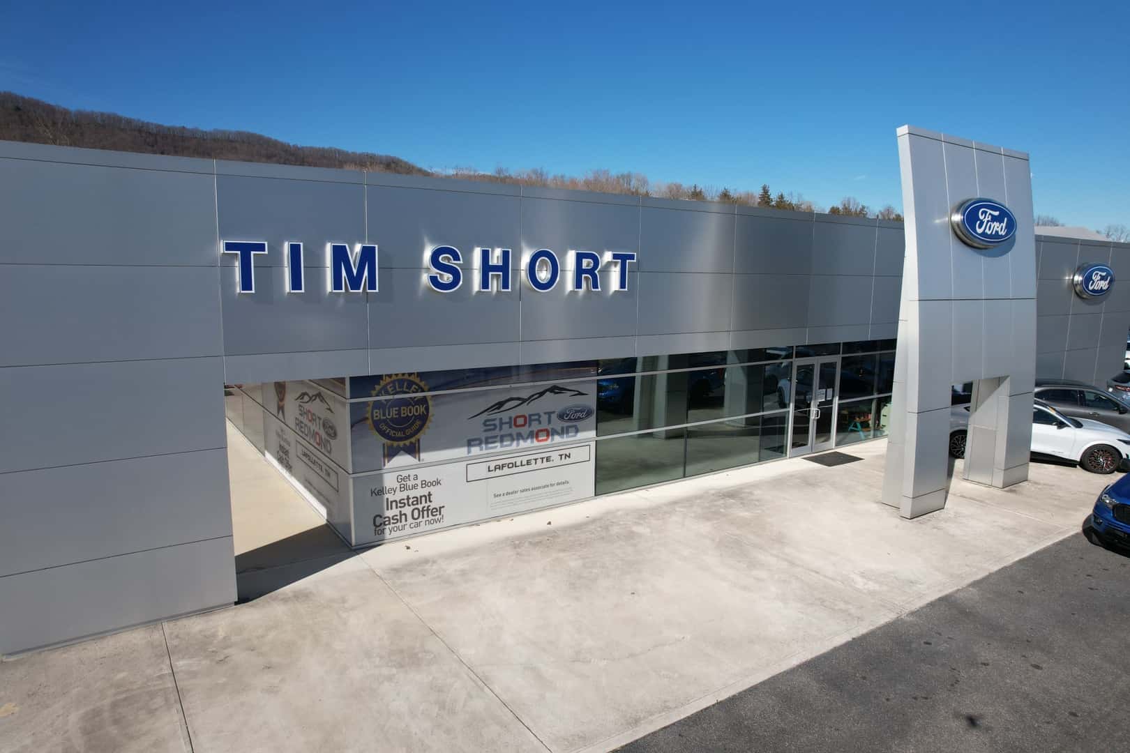 Short-Redmond Ford Dealership Exterior View with an American flag patterned whacky waving inflatable arm flailing tube man
